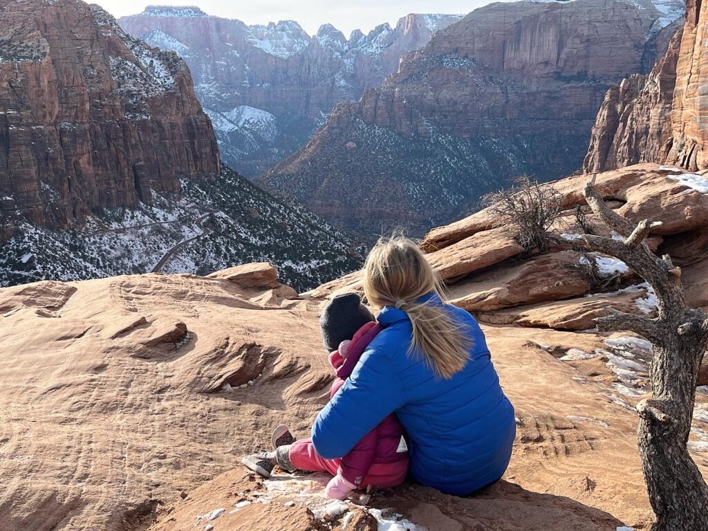 Two kids look out to Zion Canyon from the Zion Canyon Overlook trail at Zion National Park.