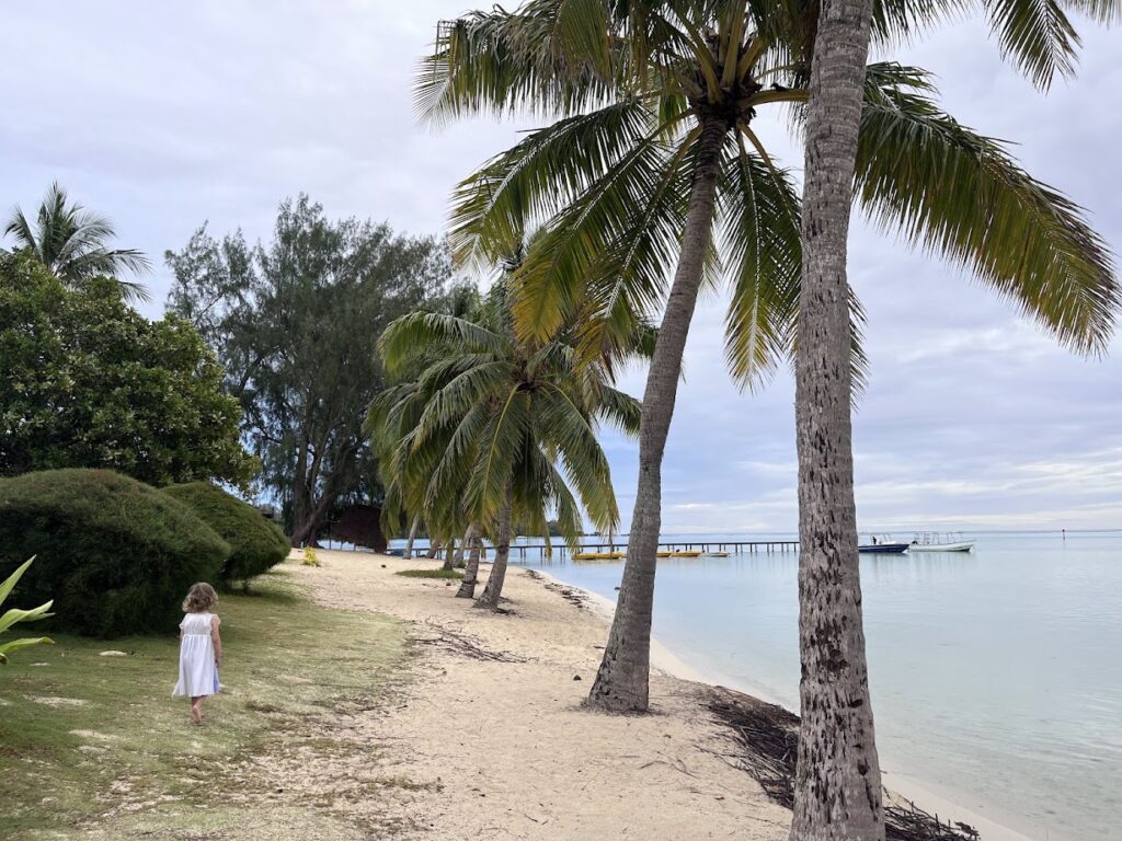 A small child walking on Tipaniers Beach in the morning.